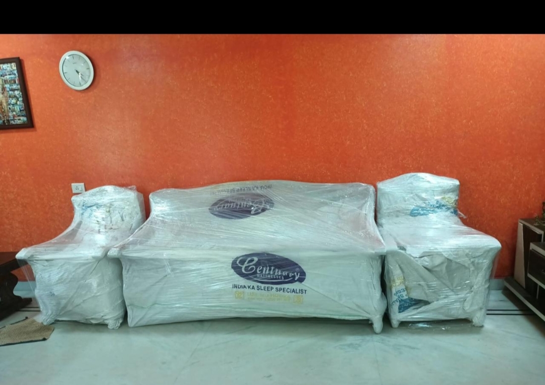 Furniture protected with quilted wrap and stretch film